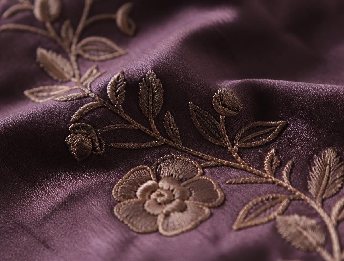 Hand embroidery detail on plum silk